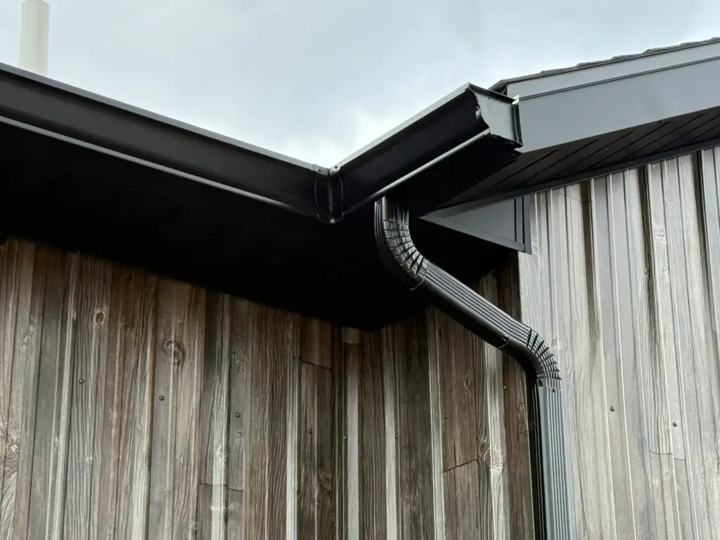 Gutter with downspout on new construction in the Helena Valley